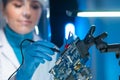 Female microelectronics engineer works in a scientific laboratory on computing systems and microprocessors. Professional Royalty Free Stock Photo