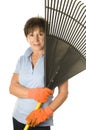 Female middle age senior gardener leaf rake Royalty Free Stock Photo