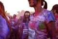 Young woman fully covered in colored powder jokingly poses like a zombie at the Color Walk in Dubai, United Arab Emirates.