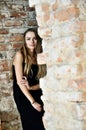 Woman in blak dress inside ruins