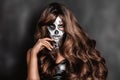 Female in Halloween silence. Sexy woman in top hat and skull make up. Halloween makeup Royalty Free Stock Photo