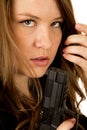 Female model holding pistol close up serious expression