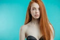 Female model with red loose hair and natural make-up posing over Royalty Free Stock Photo