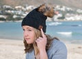 Female model wearing gray knitted beanie with Bluetooth speakers