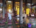 a female monk cleaning the temple floor