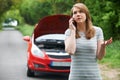 Female Motorist Phoning For Help After Breakdown Royalty Free Stock Photo