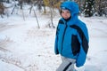 Female mountainer surrounded with snow covered forest. Royalty Free Stock Photo