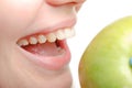 Female mouth and green apple close up