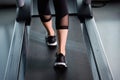 Female muscular feet in sneakers running on treadmill at gym Royalty Free Stock Photo