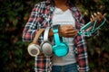 Female music fan holds headphones in summer park