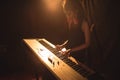 Female musician playing piano in illuminated nightclub Royalty Free Stock Photo