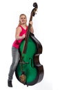 Female musician with red shirt plays on a double bass Royalty Free Stock Photo