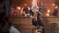 Female musician singing jazz on her saxophone in a club Royalty Free Stock Photo