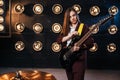 Female musician in suit playing on electric guitar Royalty Free Stock Photo