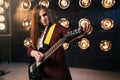 Female musician in suit playing on electric guitar Royalty Free Stock Photo