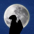 Female muslim praying under blue moon