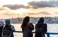 Female muslim tourists watching the sunset at the Corniche park at Uskudar, Istanbul, Turkey, on the Anatolian shore of the