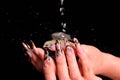 Female nails and falling drops of water