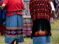 Female Native American Dancers at a Pow Wow Wearing Decorated Skirts and Fringed Shawls