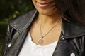 Female neckline wearing tiny silver chain with silver pendant