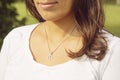 Female neckline wearing tiny silver chain with silver pendant