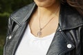 Female neckline wearing tiny silver chain with silver pendant