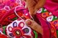 female needlework on fabric material close up view,Unidentified Tribal women sewing ethnic dresses,ahir embroidery art work close