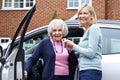 Female Neighbor Giving Senior Woman A Lift In Car