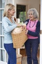 Female Neighbor Helping Senior Woman With Shopping