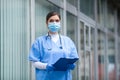 Female NHS doctor standing outside of medical clinic Royalty Free Stock Photo