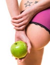 Female with nice buttocks and apple in hand