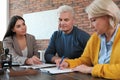Female notary working with mature couple Royalty Free Stock Photo