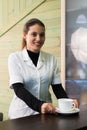 Female nurse at desk making coffee working in a modern office Royalty Free Stock Photo