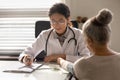 Female nurse examine mature patient at consultation Royalty Free Stock Photo