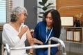 Female nurse gives a dose of insulin to diabetic senior woman during home visit. Diabetes, healthcare and age concept