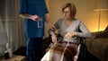 Female nurse giving pills to hospital patient in wheelchair, rehabilitation Royalty Free Stock Photo