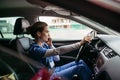 Female nurse going home from work, getting into car. Female doctor driving car to work, on-call duty, phone calling Royalty Free Stock Photo