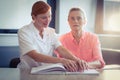 Female nurse helping patient in reading the braille book Royalty Free Stock Photo