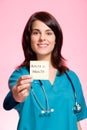 Female nurse holding an adhesive note Royalty Free Stock Photo