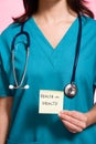 Female nurse holding an adhesive note Royalty Free Stock Photo