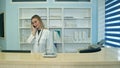 Female nurse at hospital reception answering phone calls and scheduling patient appointments Royalty Free Stock Photo