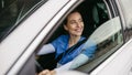 Female nurse sitting in car, going home from work. Female doctor driving car to work, on-call duty. Work-life balance of Royalty Free Stock Photo