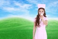 Female nurse with stethoscope with green grass field