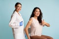 Female Nurse And Vaccinated Patient Lady Gesturing Thumbs-Up, Blue Background