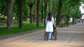 Female nurse walking in park with disabled patient, rehabilitation center Royalty Free Stock Photo