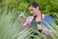 female nursery worker with clipboard inspecting plantlife Royalty Free Stock Photo