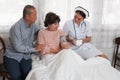 Female nurses take care of senior woman and retirement man is encouragement on the bed Royalty Free Stock Photo