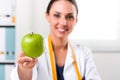 Female nutritionist giving a Green Apple Royalty Free Stock Photo