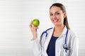Female Nutritionist holding a green apple