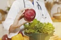 Female nutritionist showing red apples to nourish the brain Health and nutrition from experts concept.